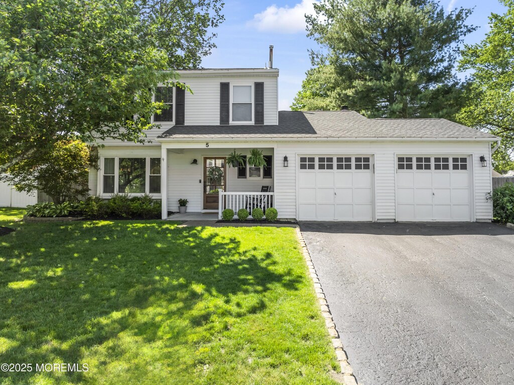 5 Blueberry Path, Howell, NJ 07731 - traditional home featuring covered porch, a garage, asphalt driveway, and a front lawn
