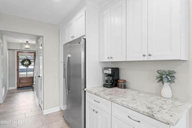 5 Blueberry Path, Howell, NJ 07731 - kitchen with stainless steel refrigerator with ice dispenser, white cabinets, baseboards, and light stone counters