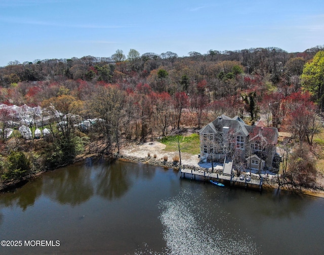 aerial view with a forest view and a water view