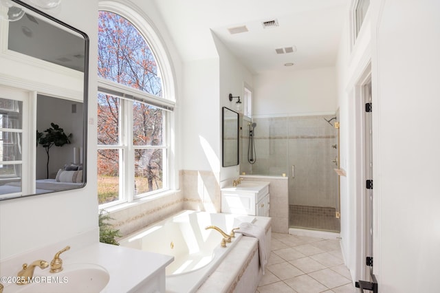 full bath featuring vanity, a jetted tub, a stall shower, visible vents, and tile patterned flooring