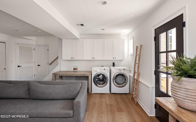 clothes washing area featuring light wood finished floors, recessed lighting, cabinet space, washing machine and clothes dryer, and visible vents
