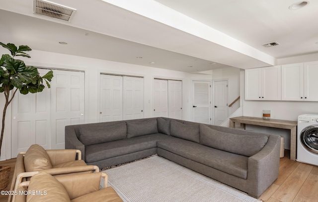 living room featuring visible vents, washer / dryer, light wood finished floors, and recessed lighting