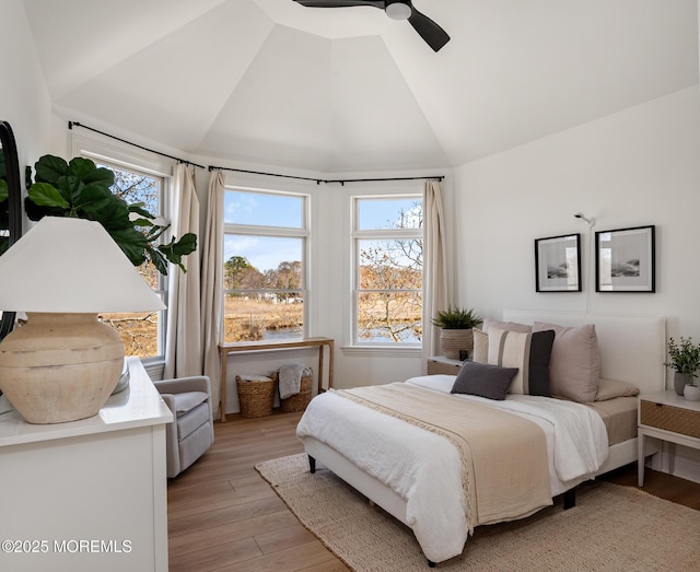 bedroom with light wood finished floors, ceiling fan, and lofted ceiling