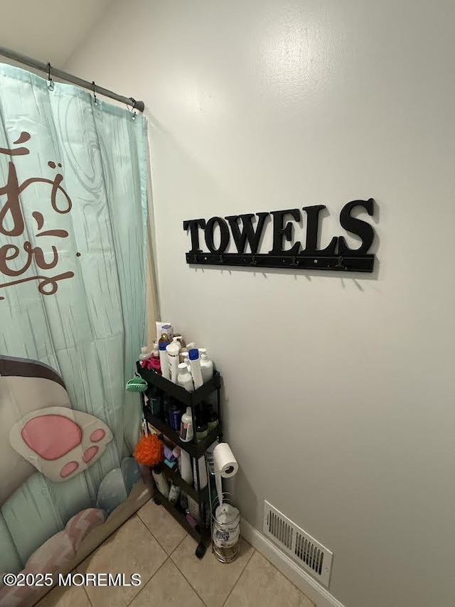 bathroom with tile patterned floors, curtained shower, and visible vents