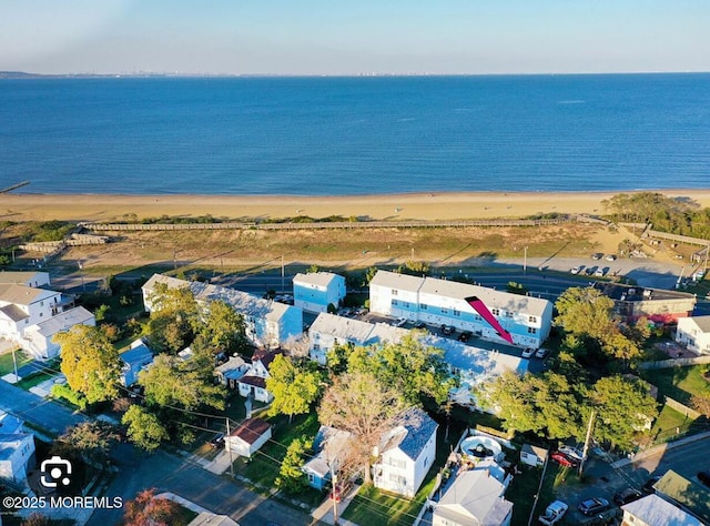 drone / aerial view featuring a view of the beach and a water view