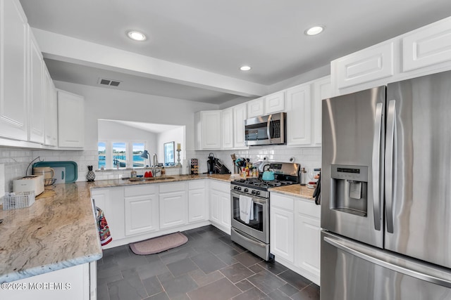 405 Sunset Dr S, Berkeley, NJ 08721 - kitchen with a sink, stainless steel appliances, tasteful backsplash, visible vents, and light stone countertops