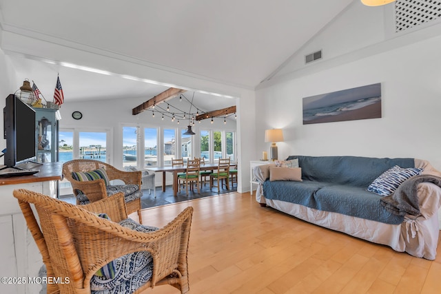 405 Sunset Dr S, Berkeley, NJ 08721 - living room with visible vents, a water view, high vaulted ceiling, wood finished floors, and beam ceiling