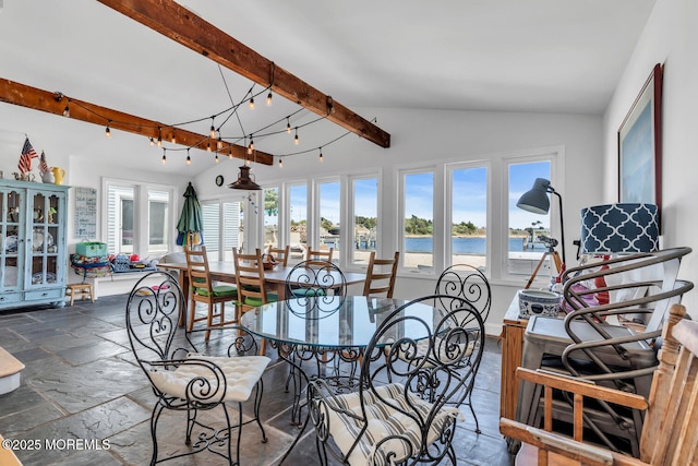 405 Sunset Dr S, Berkeley, NJ 08721 - dining area featuring a water view, stone tile floors, a wealth of natural light, and vaulted ceiling with beams