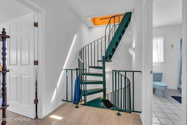 405 Sunset Dr S, Berkeley, NJ 08721 - stairway with a skylight, wood finished floors, and baseboards