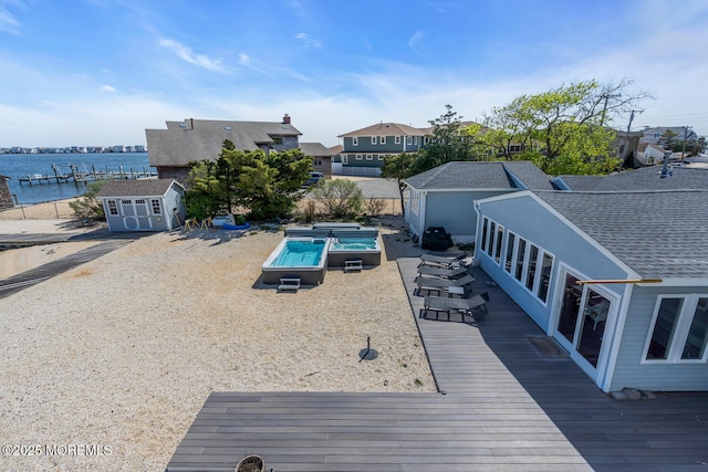 405 Sunset Dr S, Berkeley, NJ 08721 - exterior space with a water view, an outdoor structure, a hot tub, and a storage unit