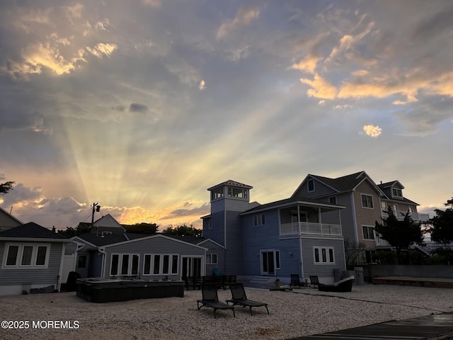 405 Sunset Dr S, Berkeley, NJ 08721 - back of property at dusk with a balcony, a hot tub, and a patio
