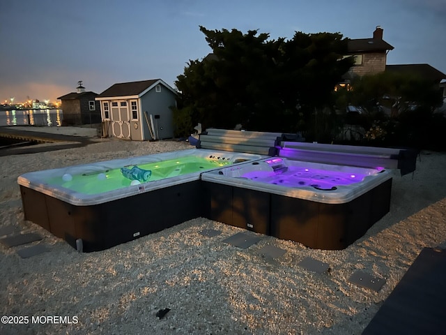 405 Sunset Dr S, Berkeley, NJ 08721 - view of swimming pool with a covered hot tub, a storage shed, and an outbuilding