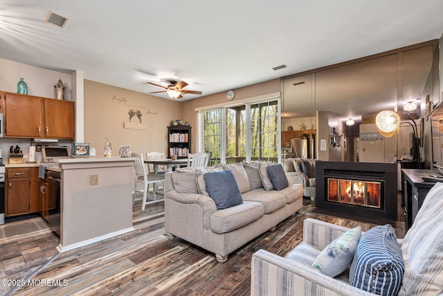 3281 Cypress Ct, Monmouth Junction, NJ 08852 - living room featuring a ceiling fan, wood finished floors, and a multi sided fireplace