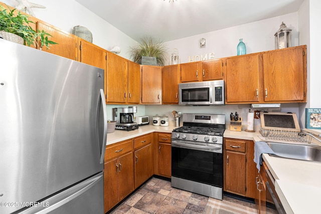 3281 Cypress Ct, Monmouth Junction, NJ 08852 - kitchen with appliances with stainless steel finishes, light countertops, brown cabinets, and a sink