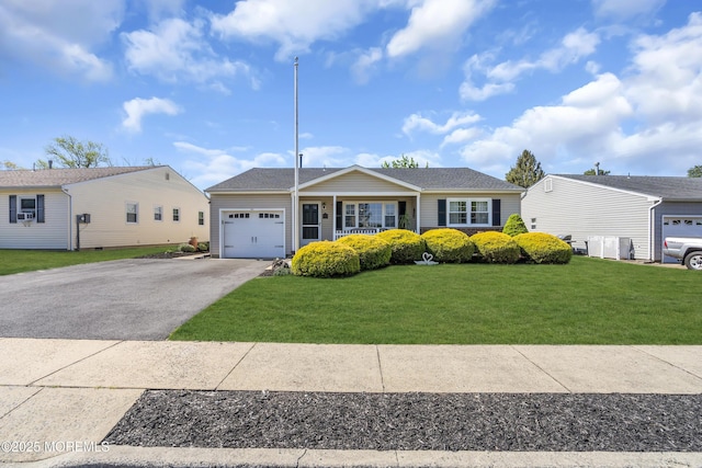 single story home featuring a garage, a front yard, and aphalt driveway