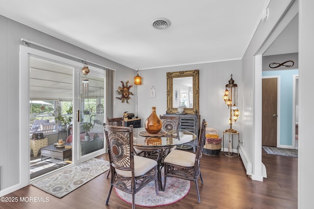 dining area featuring crown molding, baseboard heating, baseboards, wood finished floors, and visible vents