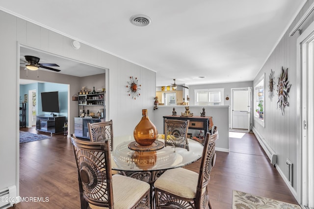 dining space with a ceiling fan, ornamental molding, and baseboard heating