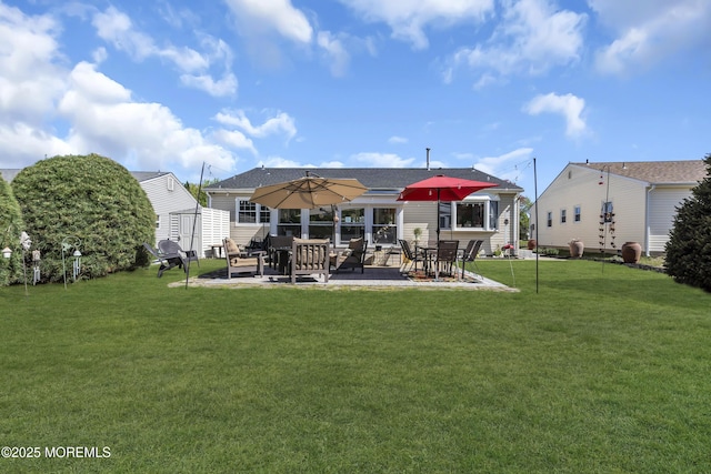 rear view of property with a patio, an outdoor structure, a lawn, and a storage shed