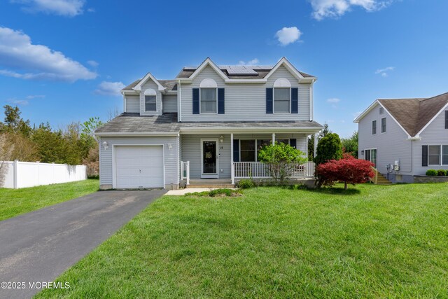 12 Red Maple Ct, South Toms River, NJ 08757 - traditional-style home with roof mounted solar panels, covered porch, and a front yard
