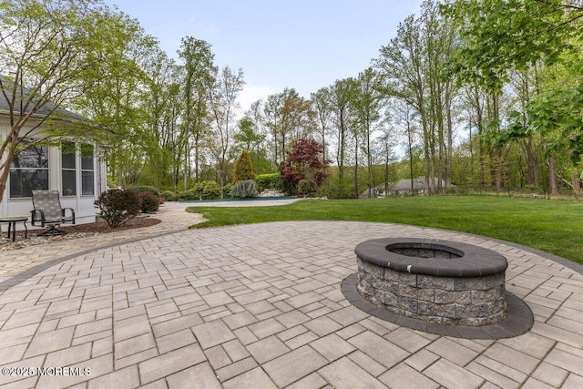 view of patio / terrace featuring an outdoor fire pit