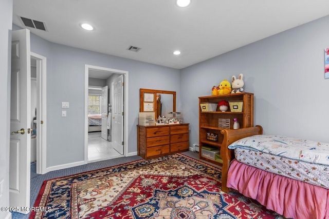 bedroom with recessed lighting, visible vents, and a baseboard heating unit