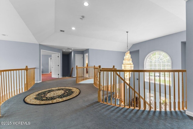 hallway with visible vents, an inviting chandelier, recessed lighting, carpet, and an upstairs landing