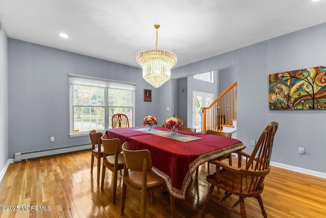 dining space featuring an inviting chandelier, light wood finished floors, recessed lighting, a baseboard heating unit, and stairway