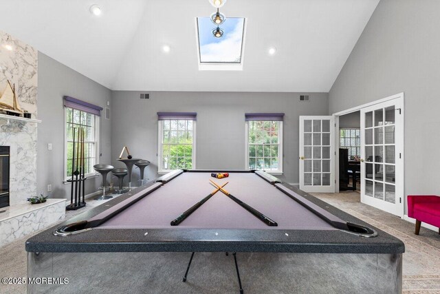 recreation room featuring a healthy amount of sunlight, high vaulted ceiling, french doors, and visible vents