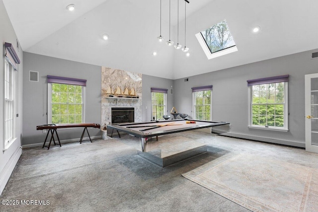 rec room featuring carpet floors, high vaulted ceiling, a stone fireplace, a baseboard radiator, and visible vents