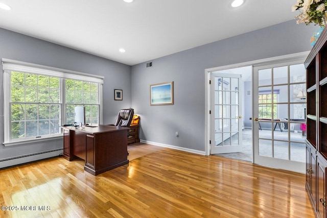 office featuring baseboards, plenty of natural light, light wood finished floors, and visible vents