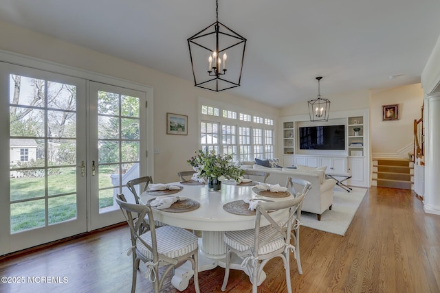 dining room featuring a healthy amount of sunlight and an inviting chandelier