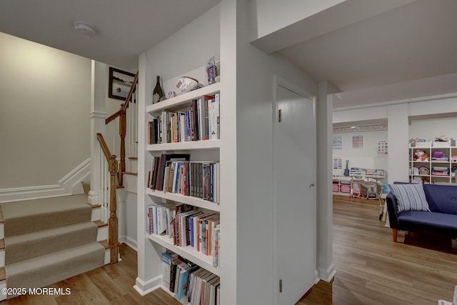 hallway with stairs and wood finished floors