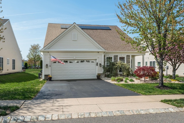 8 Ascot Ln, Manchester, NJ 08759 - view of front of property featuring a shingled roof, a garage, solar panels, driveway, and a front yard