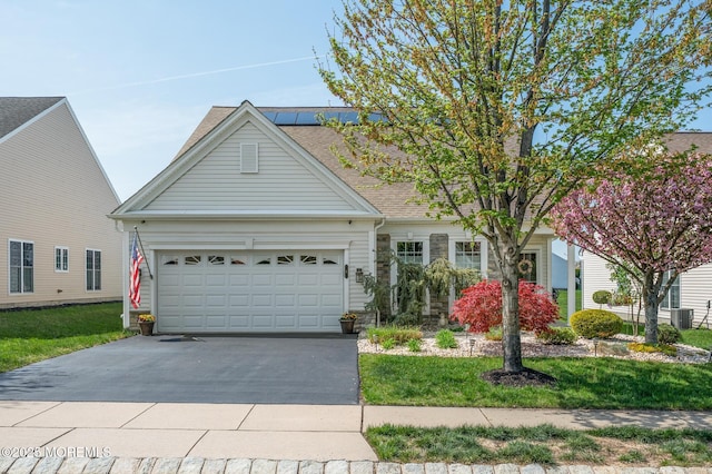 8 Ascot Ln, Manchester, NJ 08759 - view of front of property featuring concrete driveway, a shingled roof, a front yard, an attached garage, and central AC unit