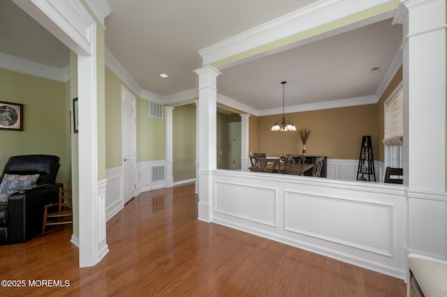 8 Ascot Ln, Manchester, NJ 08759 - interior space with a chandelier, ornate columns, wood finished floors, and a decorative wall