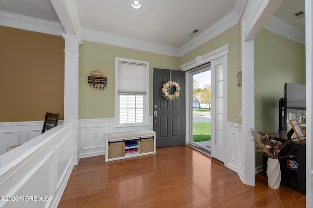 8 Ascot Ln, Manchester, NJ 08759 - foyer with wood finished floors, crown molding, visible vents, a decorative wall, and wainscoting