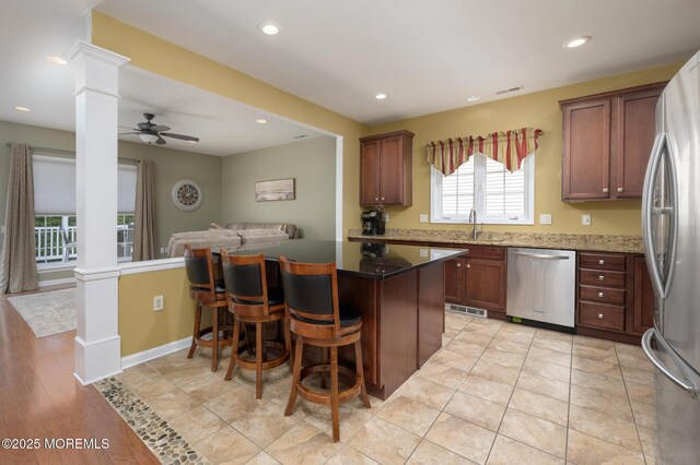 8 Ascot Ln, Manchester, NJ 08759 - kitchen with stainless steel appliances, a sink, ornate columns, a ceiling fan, and open floor plan