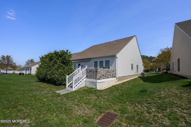 8 Ascot Ln, Manchester, NJ 08759 - back of property with a yard, central AC, and roof with shingles