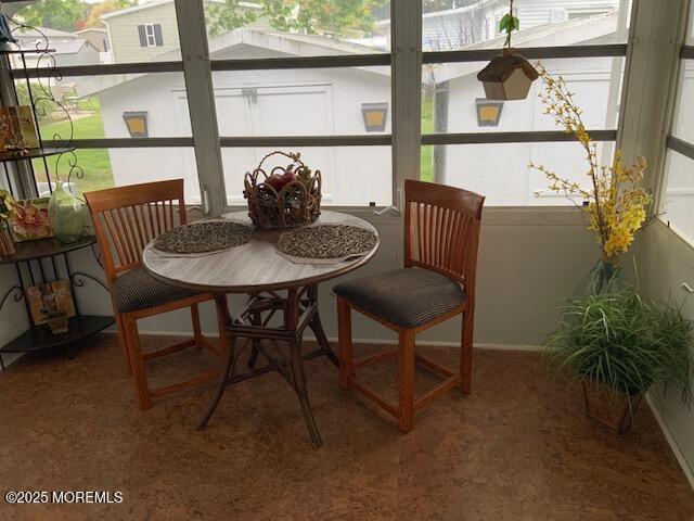 sunroom featuring baseboards