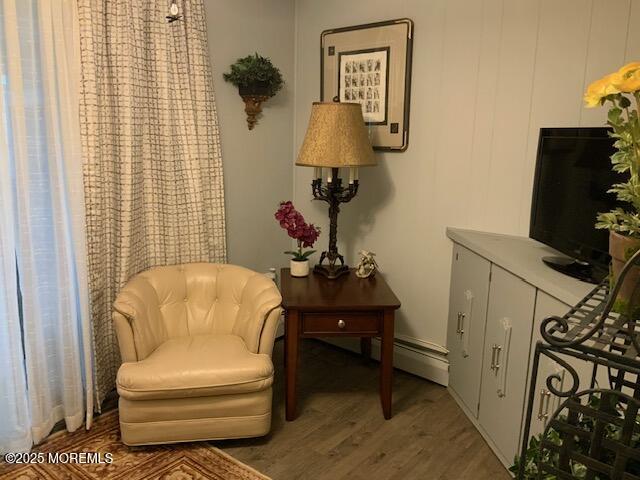 sitting room with a baseboard radiator and wood finished floors