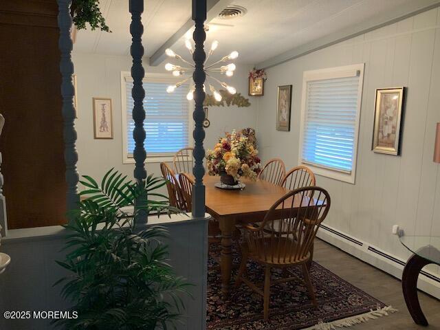 dining space with visible vents, wood finished floors, a notable chandelier, and a baseboard radiator