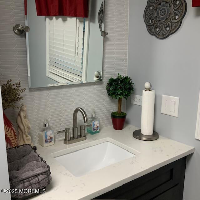 bathroom with vanity and tasteful backsplash