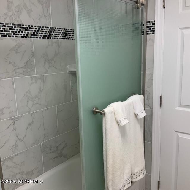 bathroom with bathing tub / shower combination