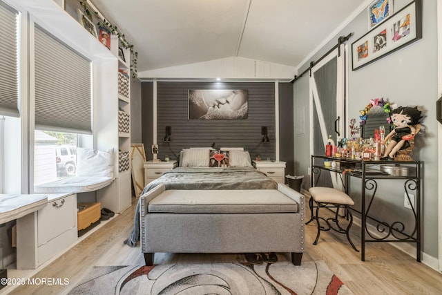 501 Ln F, Hazlet, NJ 07730 - bedroom with vaulted ceiling, a barn door, and light wood-style flooring