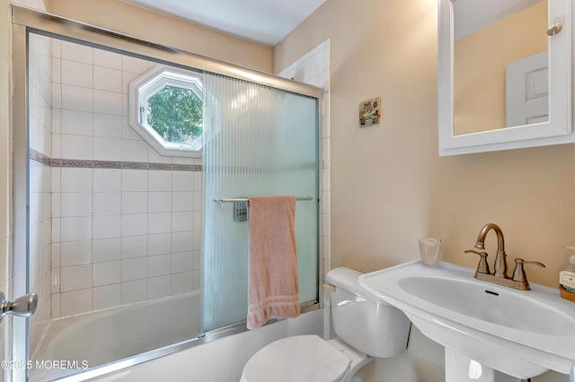 957 Harrison Rd, Toms River, NJ 08753 - bathroom featuring a sink, toilet, and combined bath / shower with glass door