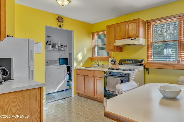 957 Harrison Rd, Toms River, NJ 08753 - kitchen featuring under cabinet range hood, gas stove, washer / clothes dryer, a sink, and healthy amount of natural light