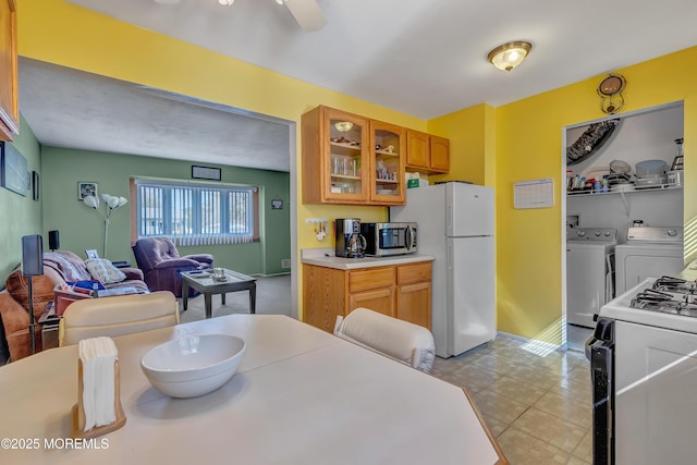 957 Harrison Rd, Toms River, NJ 08753 - kitchen with white appliances, washer and dryer, glass insert cabinets, light countertops, and brown cabinets
