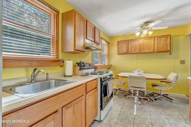 957 Harrison Rd, Toms River, NJ 08753 - kitchen with gas range gas stove, under cabinet range hood, a sink, light countertops, and a ceiling fan