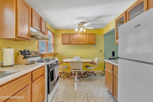 957 Harrison Rd, Toms River, NJ 08753 - kitchen with white appliances, under cabinet range hood, light countertops, a ceiling fan, and glass insert cabinets