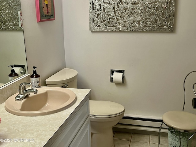 half bath featuring tile patterned floors, a baseboard radiator, vanity, and toilet